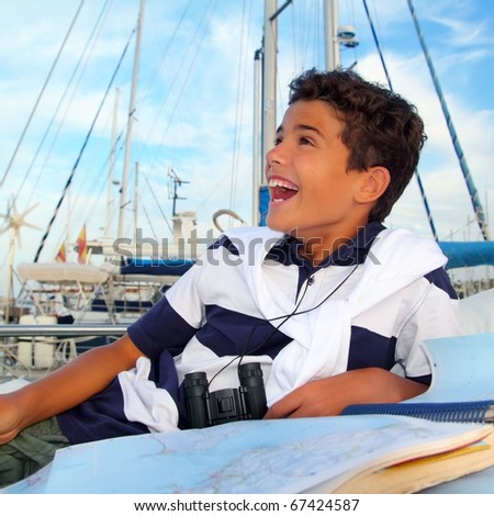stock photo boy teen sailor laying on marina boat chart map smiling in 