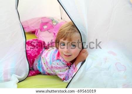 girl in camping tent lying happy on camp tent