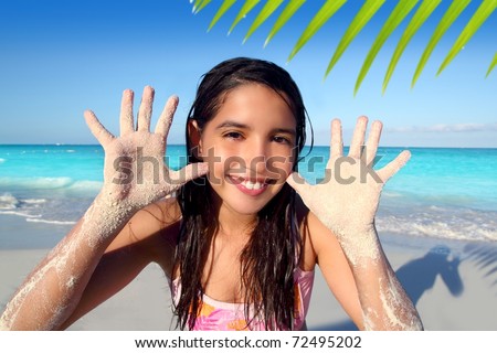 stock photo latin indian teen girl playing beach showing sandy hands in 