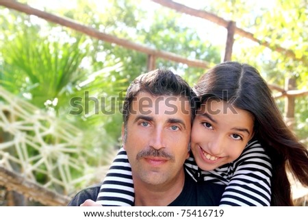 Hispanic latin father and teen daughter hug park outdoor Mexico