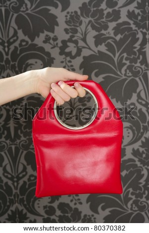 red handbag retro vintage fashion bag on sixties wallpaper
