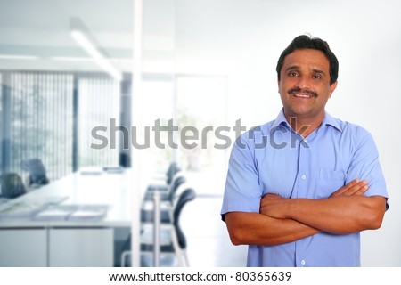 Indian latin businessman with blue shirt in modern office background [Photo Illustration]