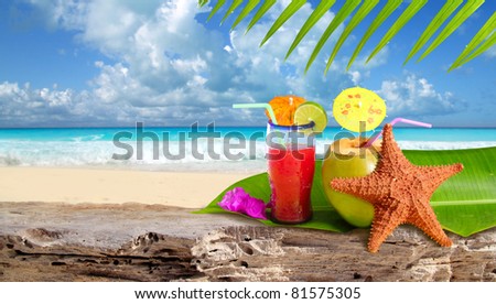 Coconut tropical cocktail with starfish over a Caribbean beach rock [Photo Illustration]