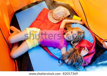 Children girl lying on camping tent floor in vacation
