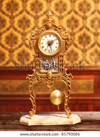 ancient vintage brass pendulum clock in classic indoor [Photo Illustration]