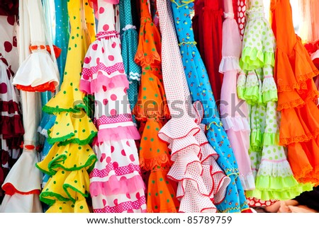 stock photo : colorful gipsy flamenco dresses on rack hanged in Spain market