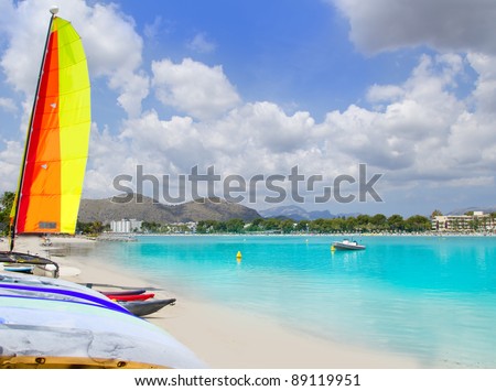 Beach of Puerto de Alcudia in Mallorca  with hobie cat and kayak on Balearic Islands Spain