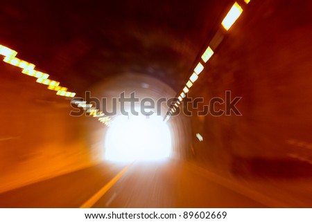 blurred motion tunnel like driving drunk metaphor with light at the end