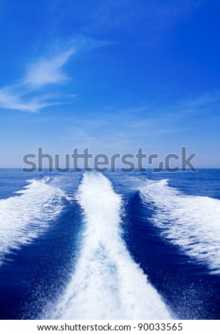 Boat wake prop wash on blue ocean sea in sunny day