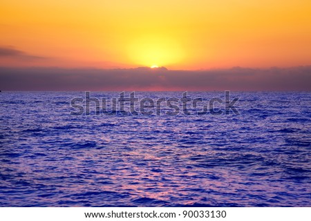 Mediterranean sea sunrise with orange sky and purple ocean