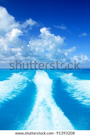 Boat wake prop wash on turquoise sea in sunny day