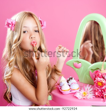 fashion little doll girl in pink vanity mirror with lipstick
