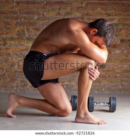 muscle shaped man on knee thinking with thinker posture