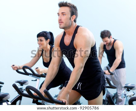 Stationary bicycles fitness man in a gym sport club