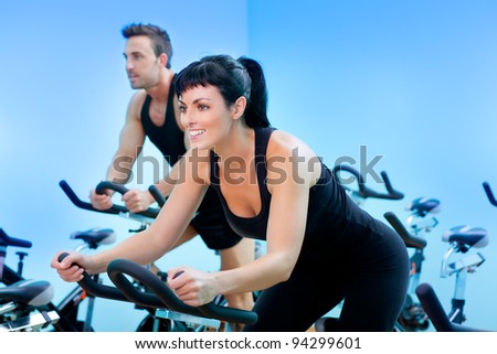 Stationary bicycles fitness girl in a gym sport club