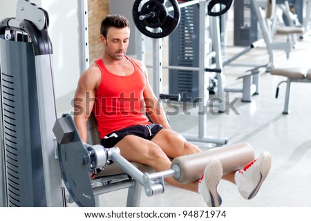 Gym fitness club indoor with young man training weights with legs