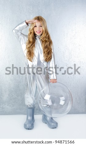 Astronaut futuristic kid girl with silver full length uniform and glass bubble helmet