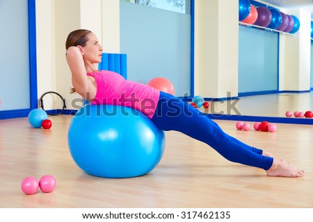 Pilates woman fitball swiss ball exercise workout at gym indoor