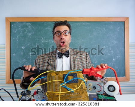 Nerd electronics technician retro teacher silly expression with big battery clamps in pcb