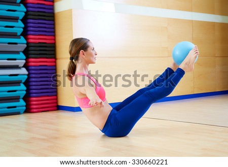 Pilates woman stability ball teaser exercise workout at gym indoor