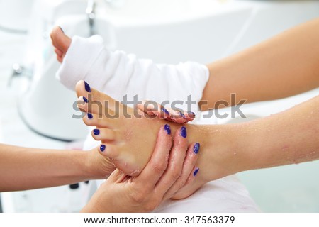 foot scrub pedicure woman leg in nail salon on chair sofa