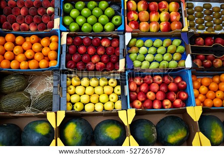 Fruits background in boxes display at market in spain