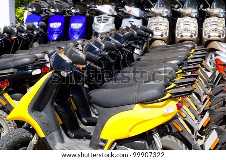 scooter bikes in rental shop in a row arrangement