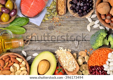 Selection of food that is good for the heart on old wooden background. Copyspace background. Top view.