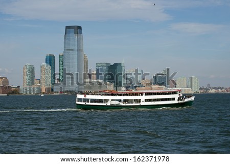 Jersey City , New Jersey in background with party boat on hudson,river.