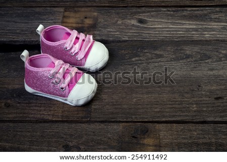 Pink babies shoes with room for your copy.