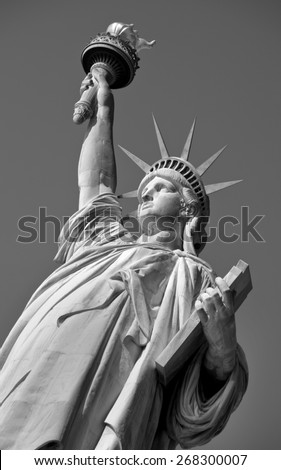 Statue of Liberty on Hudson River in NYC in black and white.