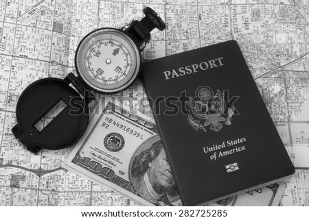 American passport ,map,compass and money in black and white.