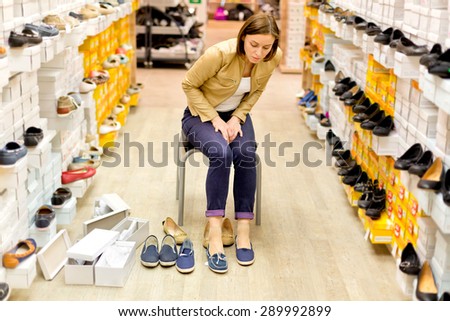 woman buys shoes in the store