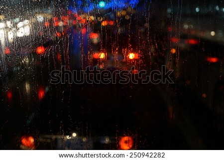 window rain blurred city lights