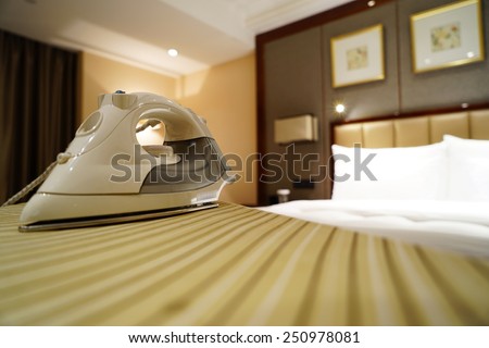 Smoothing-iron on an ironing board in hotel room