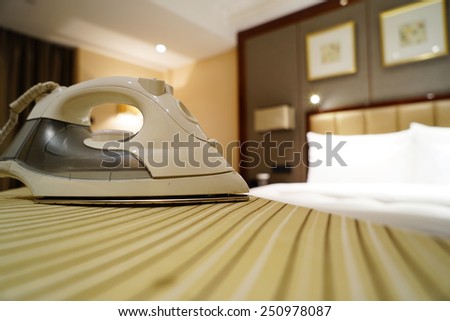 Smoothing-iron on an ironing board in hotel room