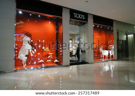 SHANGHAI, CHINA - March 2. 2015: Interior of the new IAPM Shopping Mall downtown in old French Concession. TOD\'S brand store inside Before Chinese new year at March 2. 2015 Shanghai, China