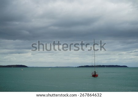 Huge storm clouds with rain over red Sailing boat