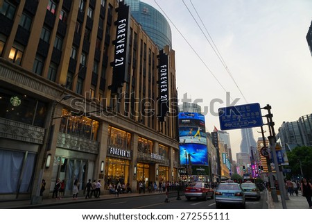 SHANGHAI CHINA - APRIL 25, 2015: Nanjing Road in the weekend in Shanghai.Nanjing Road is the main shopping street of Shanghai and here is one of the world\'s busiest shopping streets.