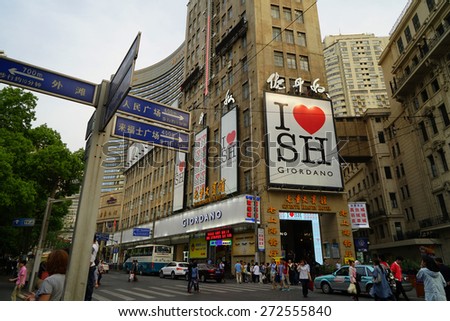 SHANGHAI CHINA - APRIL 25, 2015: Nanjing Road in the weekend in Shanghai.Nanjing Road is the main shopping street of Shanghai and here is one of the world\'s busiest shopping streets.