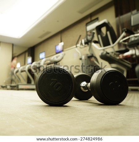 Sports dumbbells in modern sports club. Weight Training equipment.