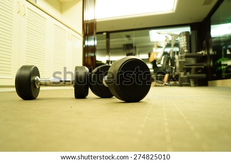 Sports dumbbells in modern sports club. Weight Training equipment.