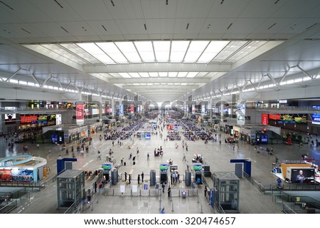 SHANGHAI, CHINA - Sept. 21, 2015: Passengers wait for trains in Shanghai Hongqiao Railway Station. It is the largest railway station in Asia with an area of 1.3 million square meters.