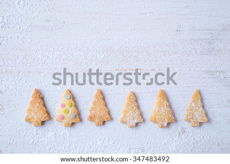 biscuits in form of fir trees decorated with sugar confetti