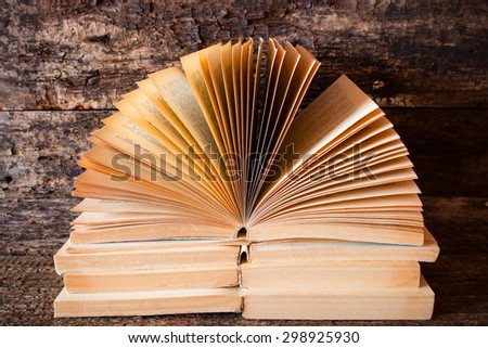 lying on each other on top of old books open book with the pages fanned out
