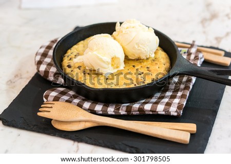 Skillet Cookies with Vanilla Ice Cream and Wood Spoon and Fork on Gloves