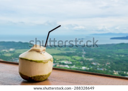Fresh Coconut Water Drink in cafe with sea view