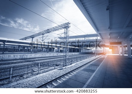 Modern high speed train at the railway station with motion blur effect