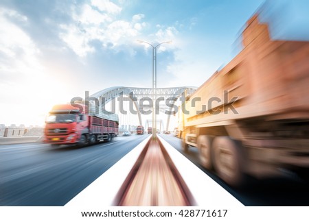 truck speeding through a bridge at sunset, motion blur.