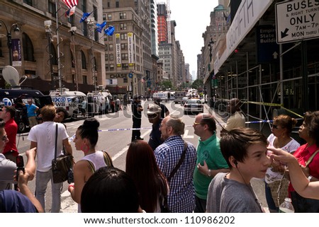 NEW YORK - AUGUST 24:  People and Media gather one block away after 2 killed and 8 injured in shooting near Empire State Building August 24, 2012  in New York City